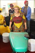 Deputy Minister pushing the water barrel to show the community how it works